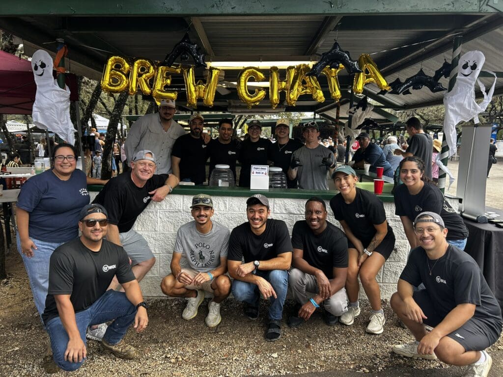 group picture in front of cooking stand