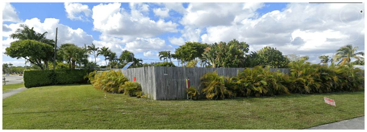 fence surrounded by trees and grass