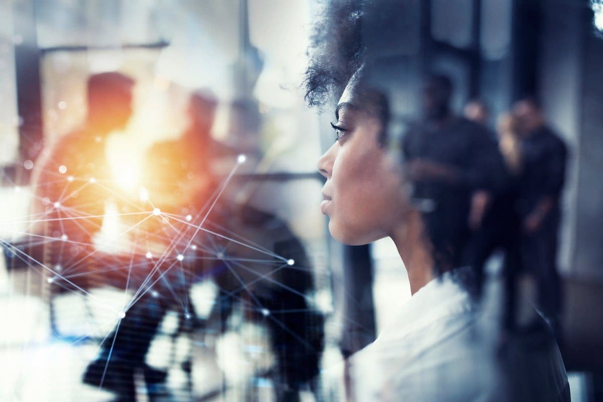 businesswoman_office_looks_into_the_distance_abstract_network_of_connections_with_colleagues_in_background_career_ideas_innovation_transformation_by_alphaspirit_gettyimages-1157314977_2400x1600-111