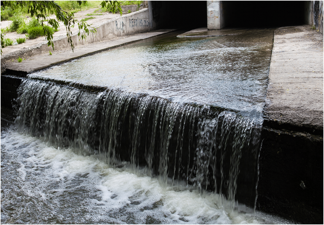Water stream flowing out the underground tunnel into the Lybid river in Kyiv.